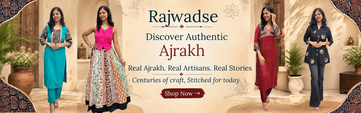A promotional banner for Rajwadse Authentic Ajrakh fabric, featuring four models wearing different colorful traditional outfits (teal, pink and multicolor, red, and black) in an indoor styled setting with a 'Shop Now' button and Explore more beautiful Ajrakh Dresses at Rajwadse .