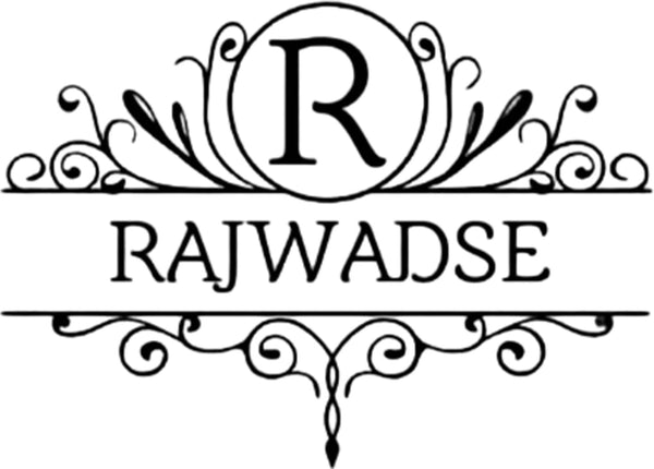 A black ornate monogram logo featuring a large letter 'R' inside a circle at the top, with the word 'RAJWADSE' centered below, and decorative scrollwork framing the design on a white background. niche is to deliver beautiful Ajrakh Dresses & work with our Indian Artisans.