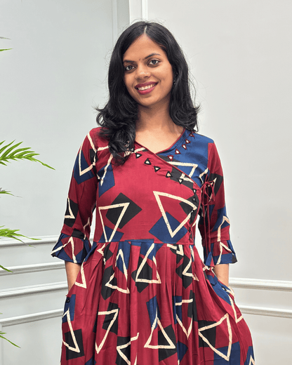 Close-up of Red women's vegetable dyed cotton long-kurti featured with hand-mirror work on V shaped-neck border, frill sleeves on calf.