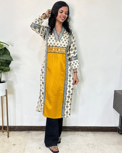 Yellow Woman's Ajrakh Pure Mashru Silk Long-Kurti with Ajrakh print panel- border on front & Sleeves cuffs, patterned dress with a yellow center against a white wall