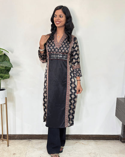 Black Woman's Ajrakh Pure Mashru Silk Long-Kurti with Ajrakh print panel- border on front & Sleeves cuffs, patterned dress with a yellow center against a white wall