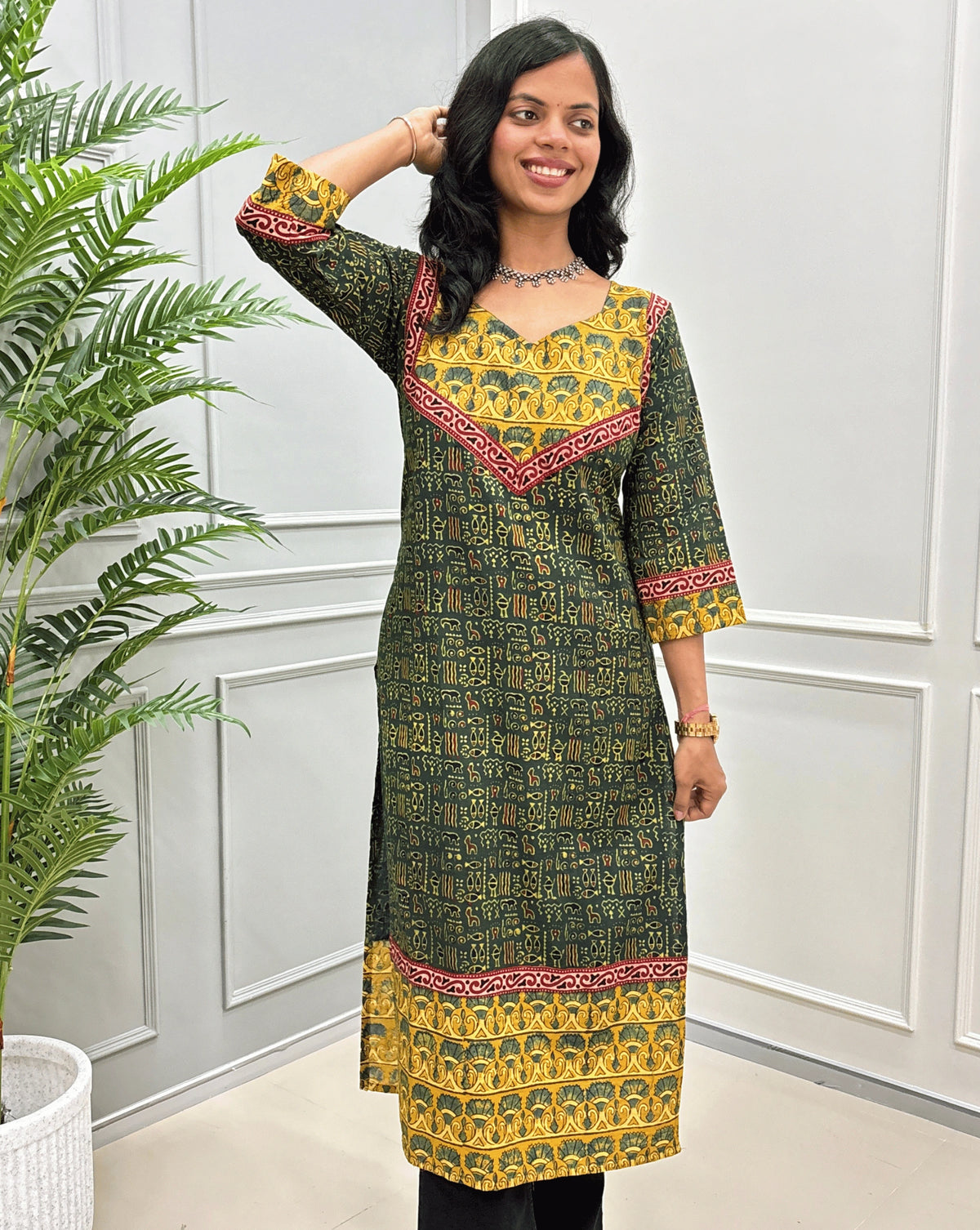 Close-up of Green Ajrakh hand-block cotton long-kurti featured with geometric ajrakh print on front & sleeves. 
