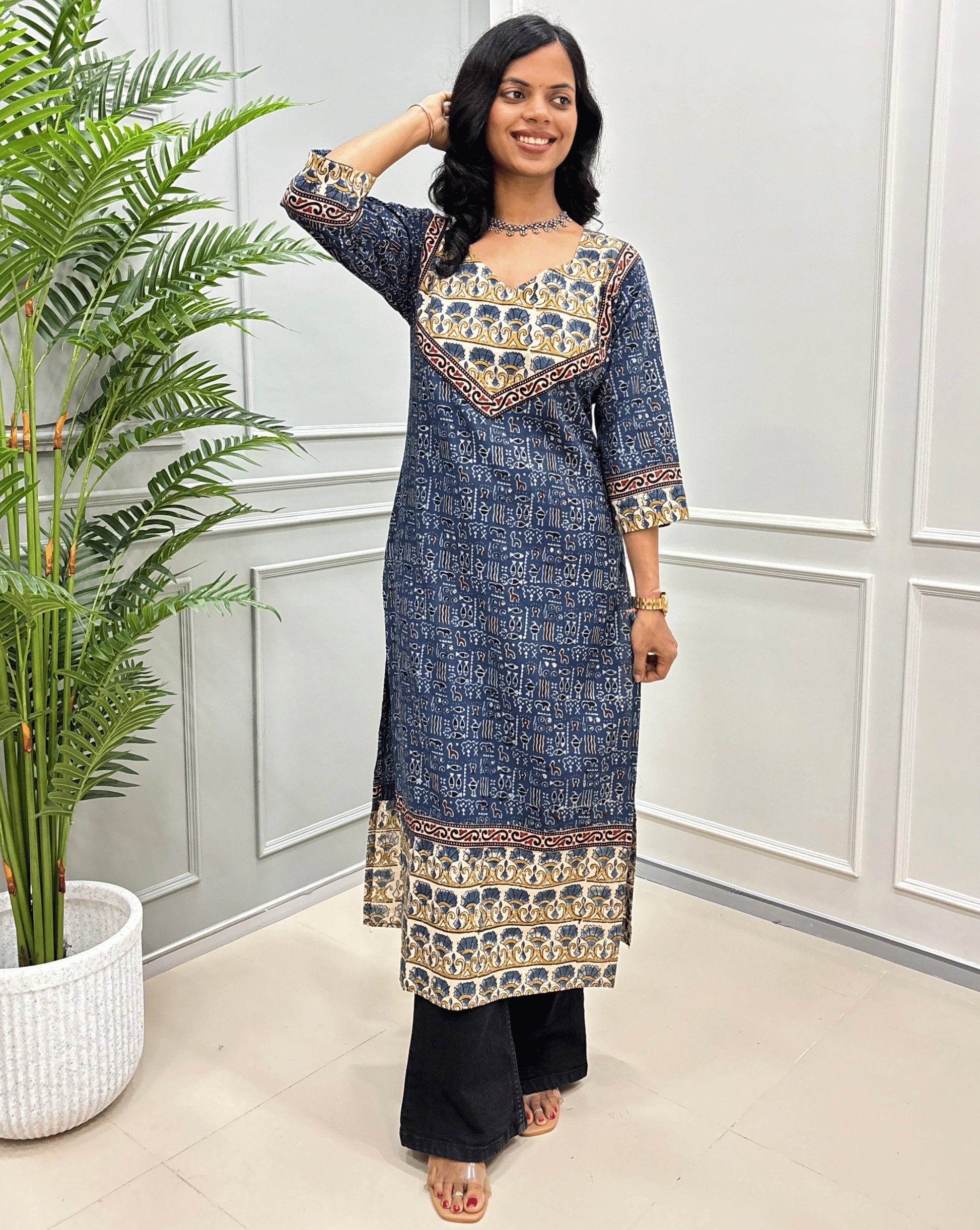 Front view of Blue & Beige Ajrakh Handcrafted Cotton Long-kurti with curved-V neck. ajrakh border-line on front and sleeves. paired with black flared jeans. 
