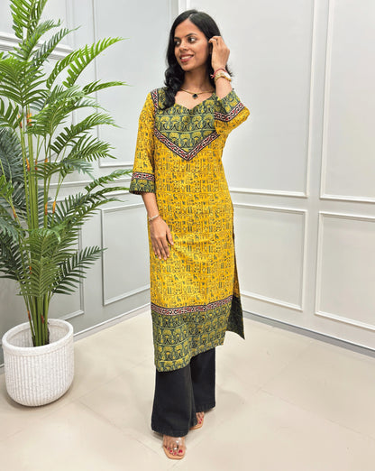 Front View of Yellow Hand-block cotton long- kurti with black border &  Ajrakh print on front and sleeves, paired with black flared jeans 