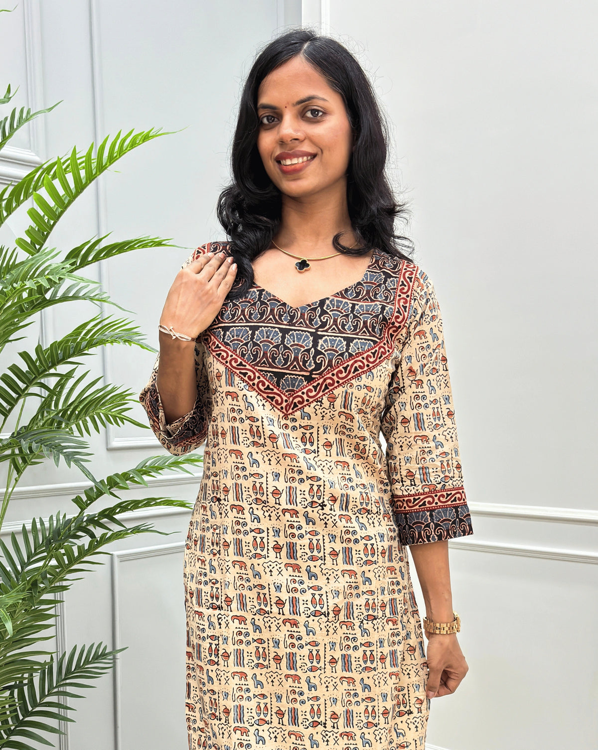 Front View of Beige Hand-block cotton long- kurti with black border &  Ajrakh print on front and sleeves, paired with black flared jeans 