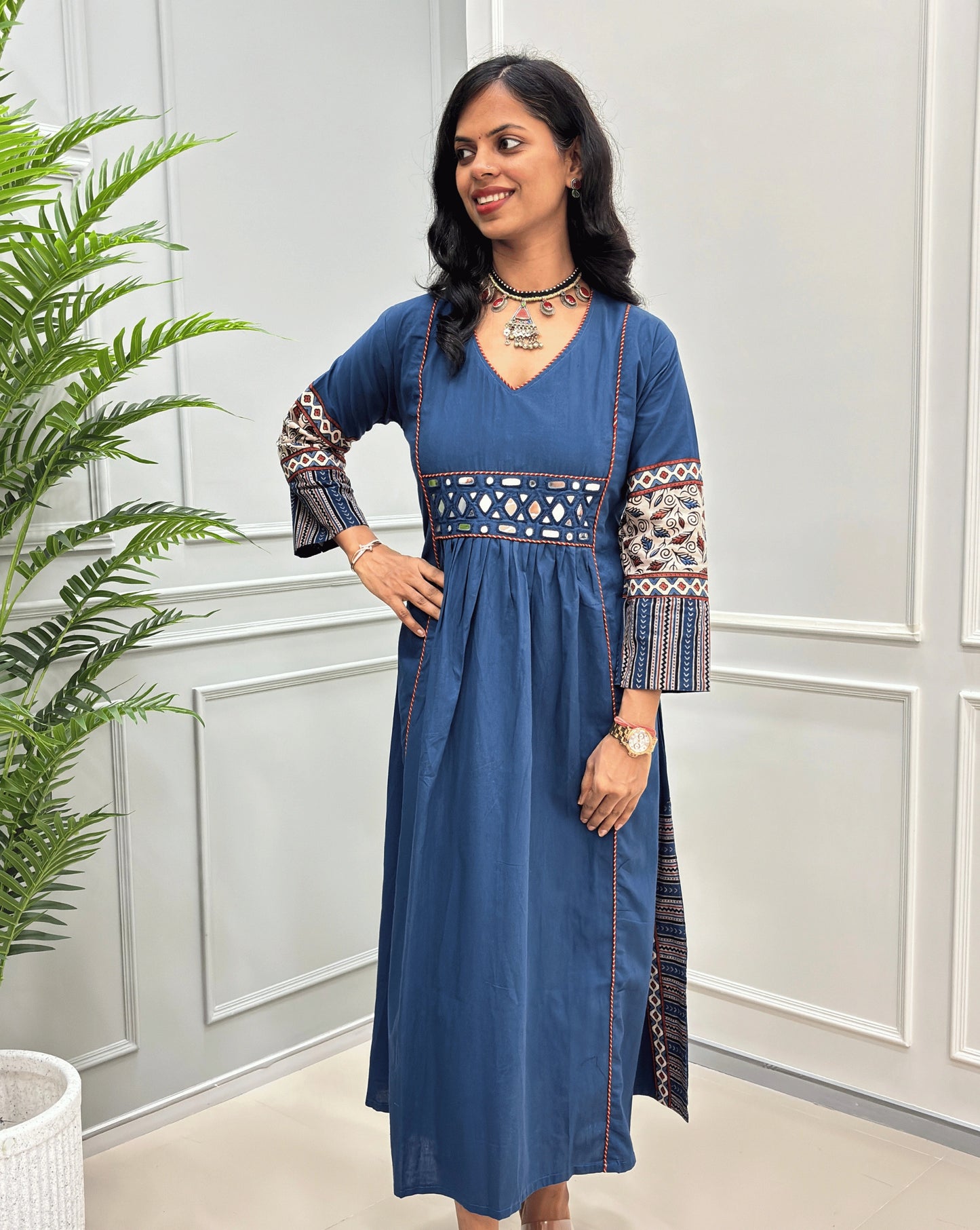 Blue women's cotton Ajrakh long kurti front view featuring geometric print on sleeves and mirror work on waist ,