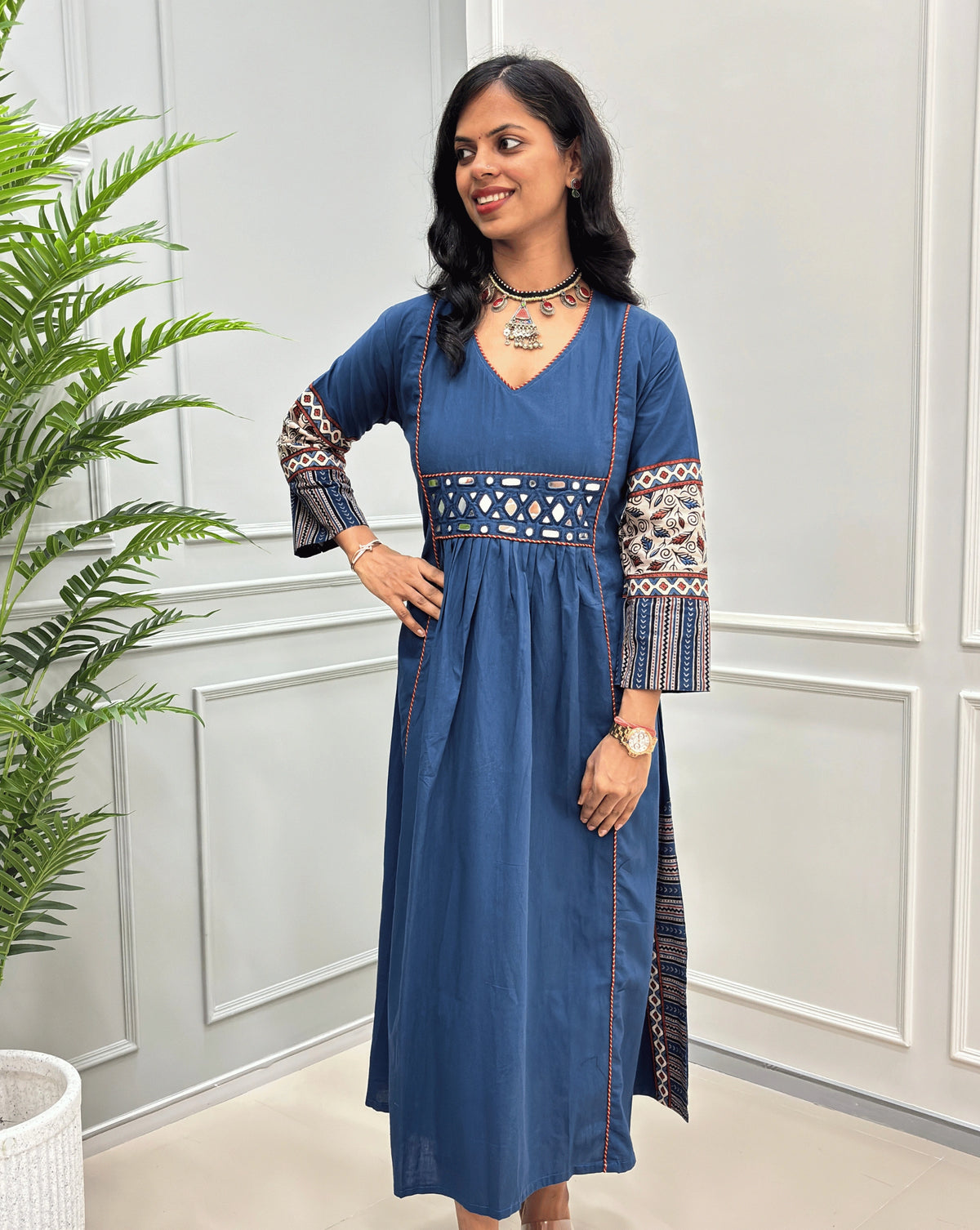 Blue women's cotton Ajrakh long kurti front view featuring geometric print on sleeves and mirror work on waist ,