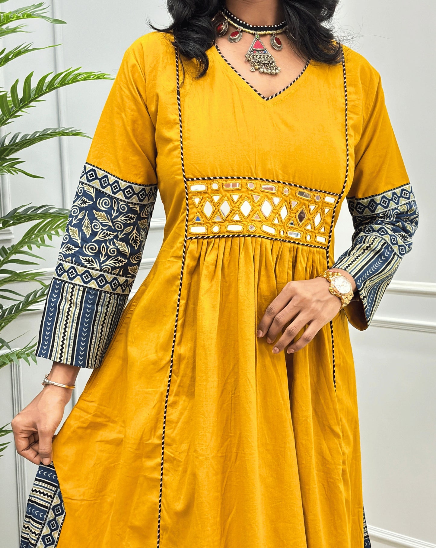 Close-up of Handblock cotton long kurti with intricate blue & beige ajrakh patterned sleeves cuffs & a mirror work embroidery.