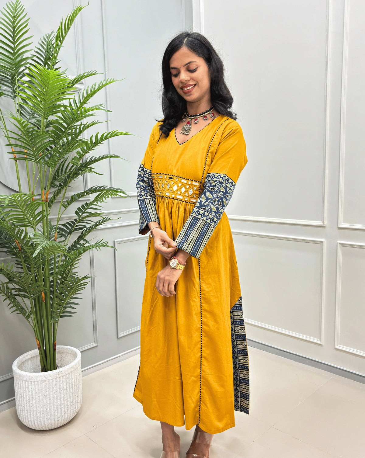 Side view of Mustard yellow long cotton Ajrakh kurti with featured handblock with blue & Beige  patterned sleeves & side pannels,  Ajrakh printed sleeve detail on yellow cotton kurti 