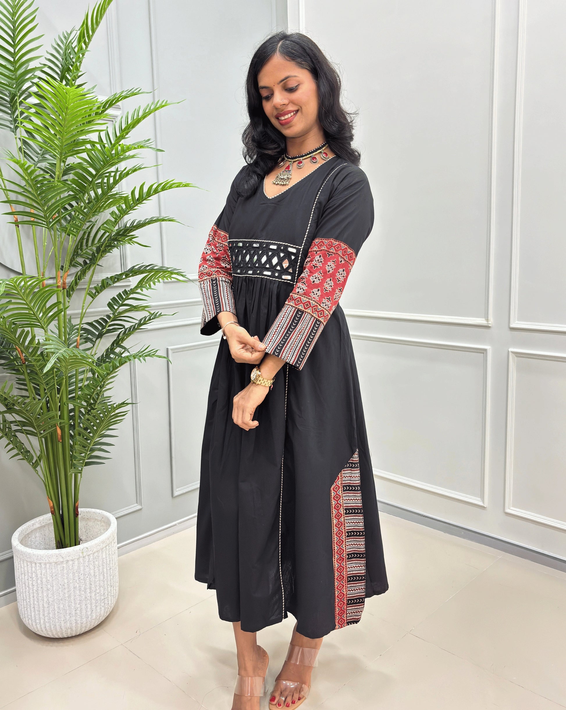 Side view of black long cotton Ajrakh kurti with red & beige ajrah printed sleeves cuffs & both side panel of kurti. 