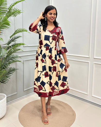 Beige Women's vegetable dyed premium Rayon Cotton long kurti with a geometric block print in navy blue and deep red. The dress features three-quarter sleeves, a V-neckline, and a self-tie waist.