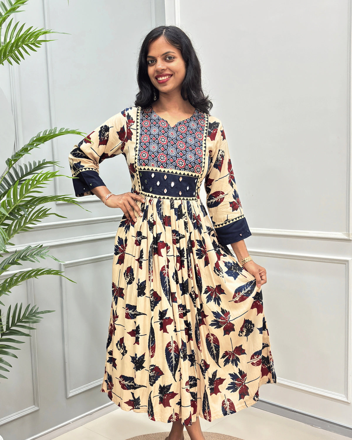 Front view of Beige women's Ajrakh plant based Cotton Long Kurti featured with Geometric print on Blue base on Curved V-neck, Hand-mirror wok on front & Sleeves cuffs. leaf print with abstract green & Red .