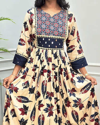 Close-up of Beige Ajrakh Plant based cotton Long-kurti featured with three-quarter sleeves , geometric print on neck-line , hand-mirror work on front chest & sleeves cuffs, Beautiful leaf print in dress., curved V-neck pattern 