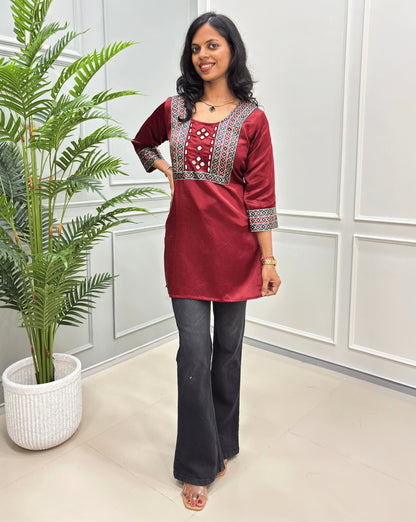 Red women's kurti with 3-quarter sleeves with silver & white geometric embroidery around the neck-line .