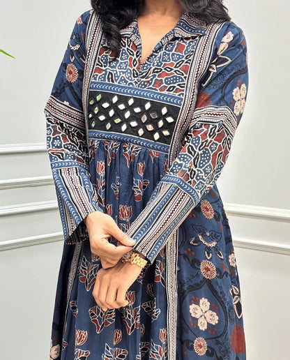 Close-up of handcrafted mirror work on blue Ajrakh cotton long-kurti dress with Ajrakh printed sleeves detail on dress. mirror work on chest. 
 