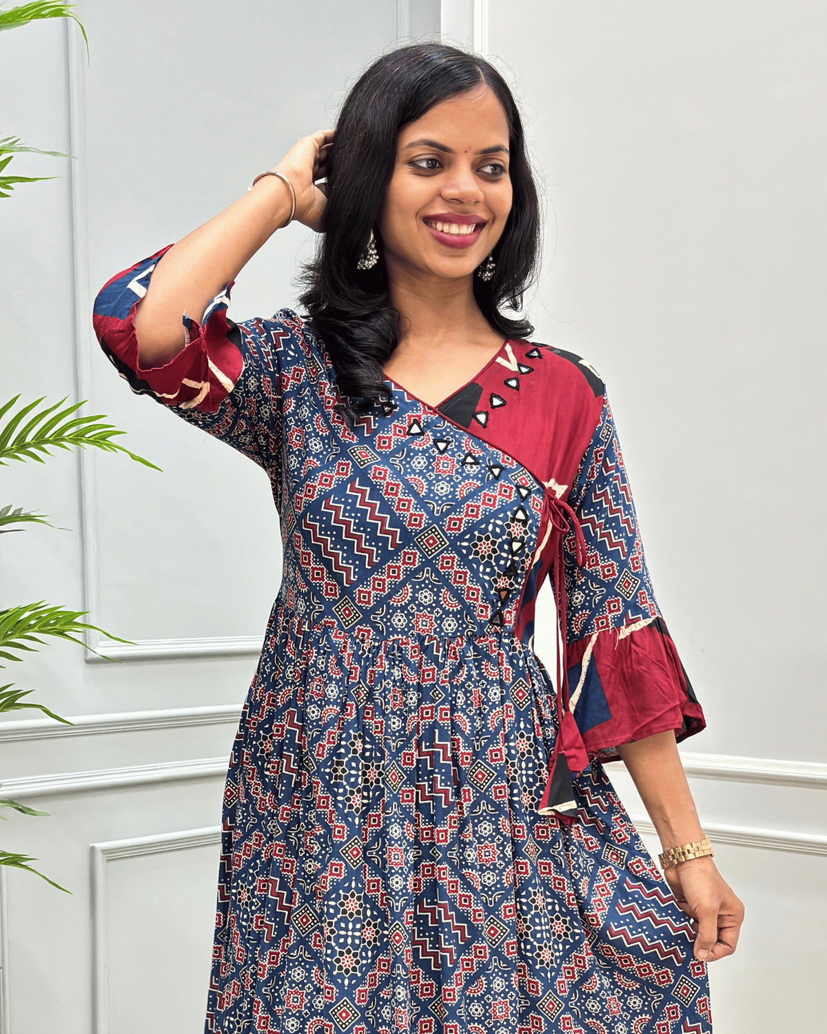 Close-up of Blue women's plant based cotton fabric with hand-mirror work on neck border with lace on chest, geometric print on sleeves calf.