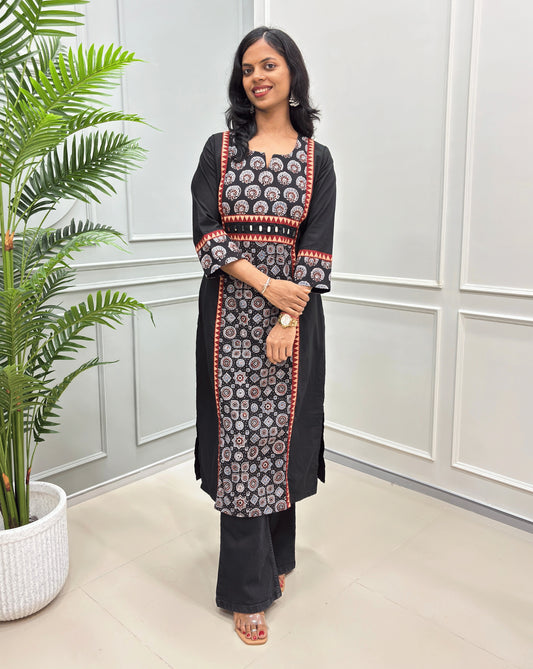 Black women's Ajrakh Hand-block pure cotton long-kurti witj three-quarter sleeves. Ajrakh print with blue, red, and beige colour, paired with black jeans.