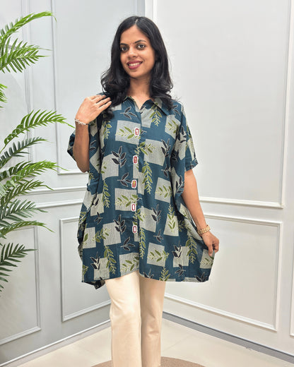 Close-up of Green women's Ajrakh Plant Based Cotton Kaftan with a patchwork pattern of beige, and green botanical motifs, paired with cream Flared Pant.