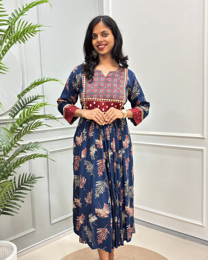Front view of Blue women's Ajrakh plant based Cotton Long Kurti featured with Ajrakh print on Red base on Curved V-neck, Hand-mirror wok on front & Sleeves cuffs. leaf print with abstract green & Red .