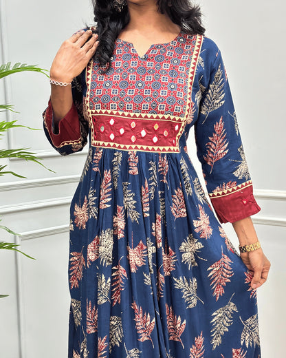 Close-up of Blue Ajrakh Plant based cotton Long-kurti featured with three-quarter sleeves , floral print on Geometric V-neck-line , hand-mirror work on front chest & sleeves cuffs, Beautiful leaf print on dress along with pocket.