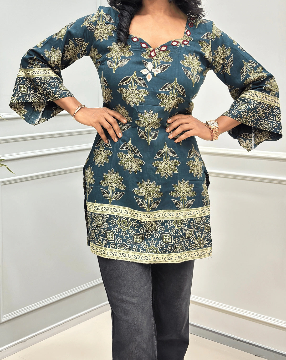 Close-up of  Green Ajrakh cotton kurti with hand-mirror embroidery on neck-line, & ajrakh print on three-quarter bell-sleeves .