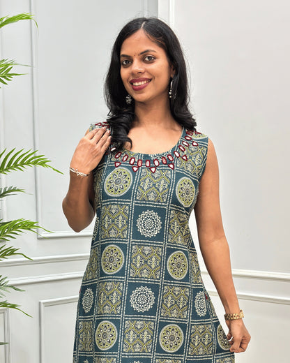 Close-up of Green Cotton Long sleeveless A-line Kurti with a geometric and circular block print & Ajrakh pattern in beige & green, featuring a red outline with thread on Hand-Mirror embroidered neckline.